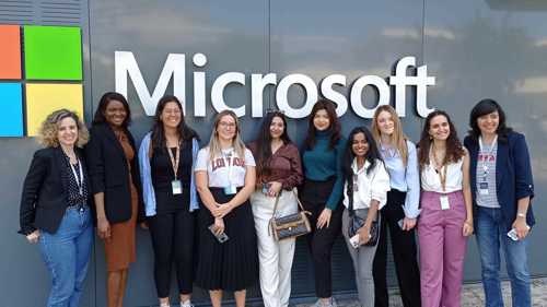 A photograph of students on field study trip in front of Microsoft logo