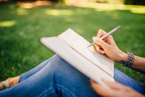 A woman writing in a notebook